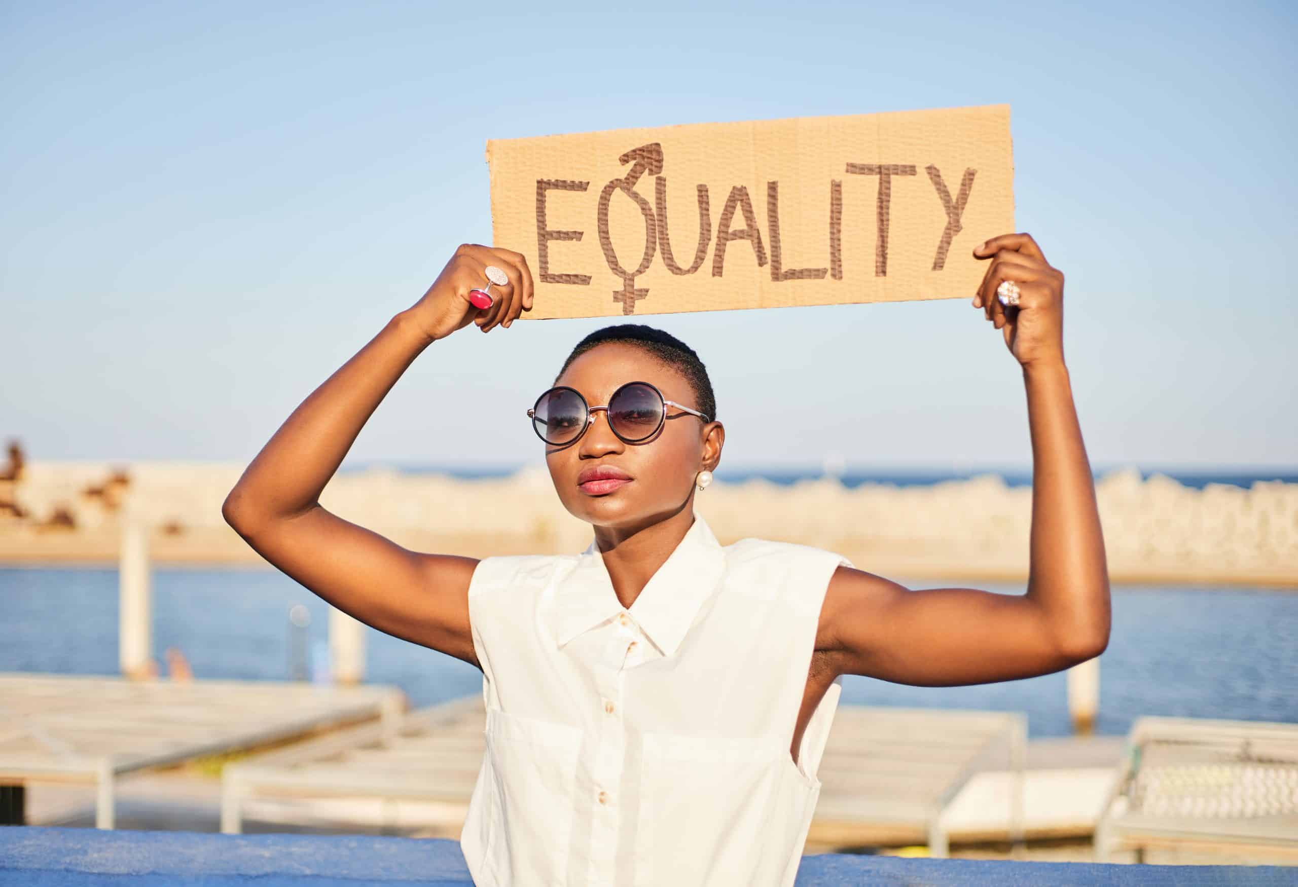 Black woman with a placard protesting for women’s rights reproductive oppression