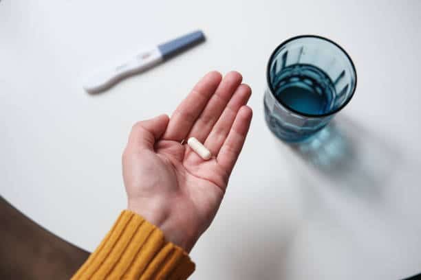 A woman holds an abortion pill, which could be banned under the Comstock Act.